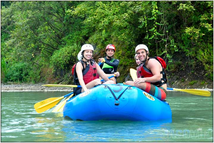 Family group on raft while white water river rafting