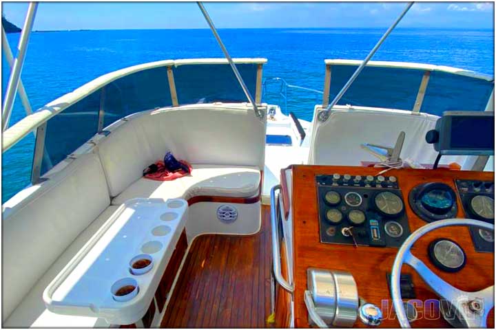 at the helm of custom party boat in costa rica