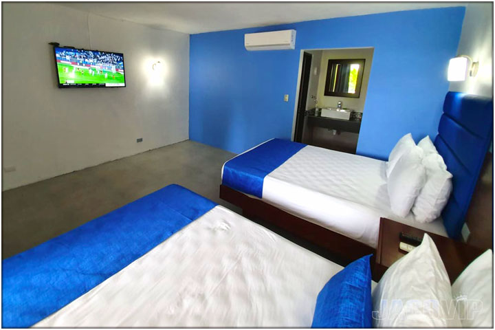 Bedroom with 2 double beds and TV
