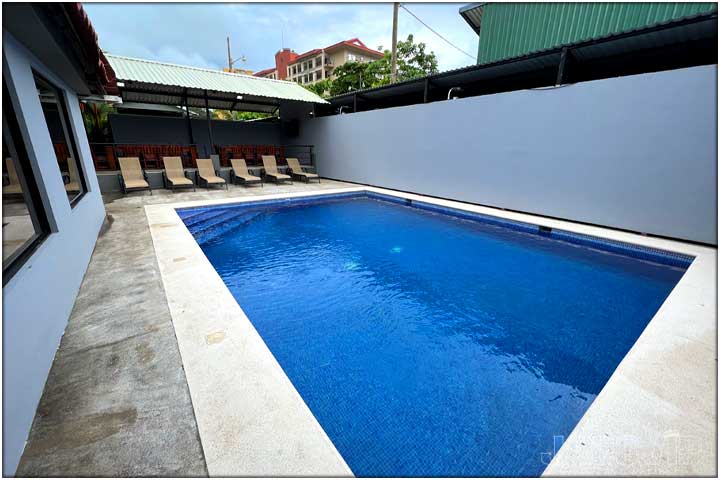 Swimming pool with guests playing inflatable ball