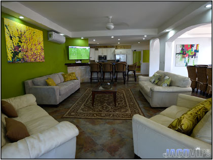 Living room area with 4 white sofas