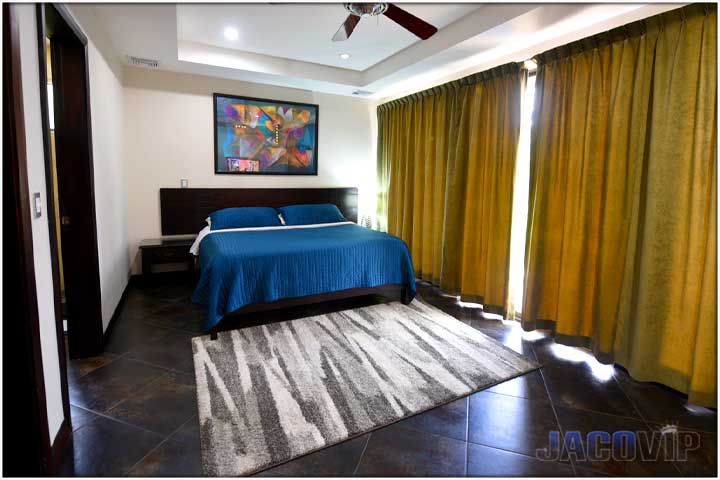 King size bed with blue cover in bedroom 3