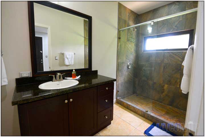 En suite bathroom with large shower and glass wall