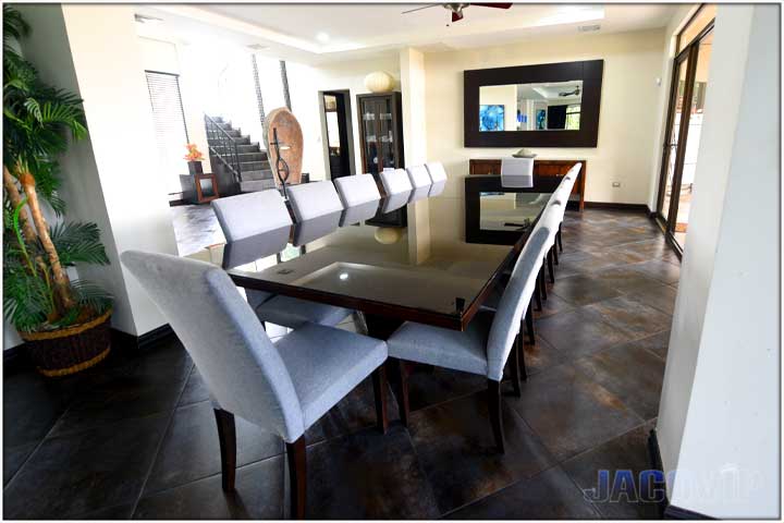 Grey upholstered chairs surrounding a large dining table