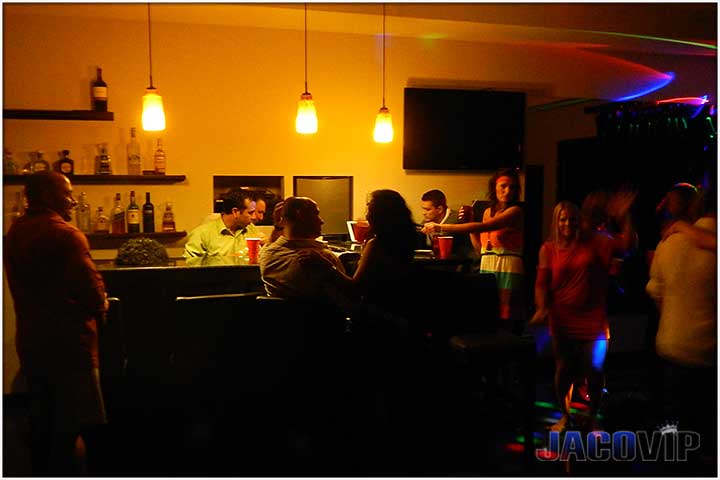 top floor party room with people at bar