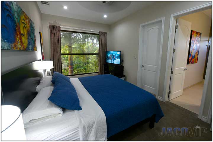 Blue duvet covers with blue artwork hanging on wall