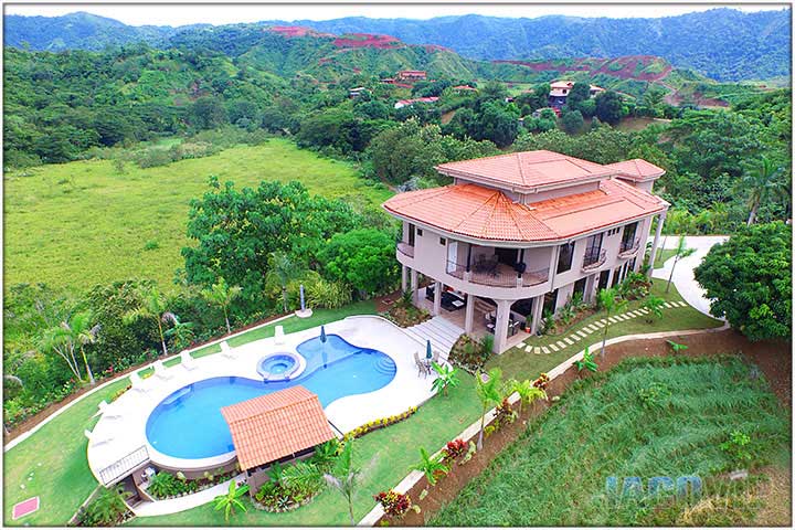 Fly by view of house and mountains