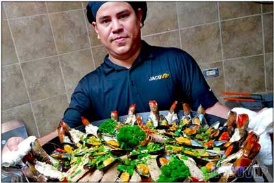 Jaco VIP Chef with giant seafood platter for dinner service