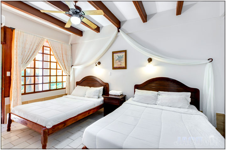 Bedroom with 2 double beds and white linens