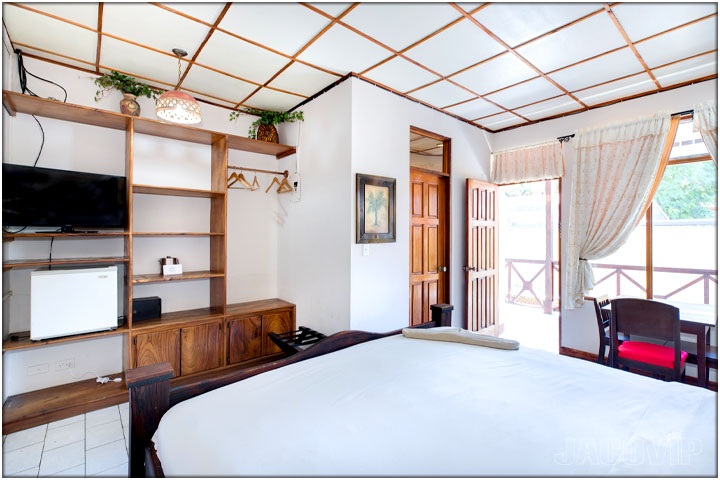 Bedroom with open door leading out to balcony area
