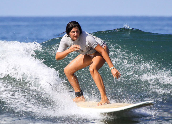 Girl taking a surf lesson in Jaco Costa Rica