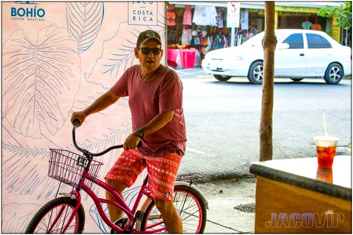 Guy on bicycle at Bohio Roasters coffee shop in Jaco Beach