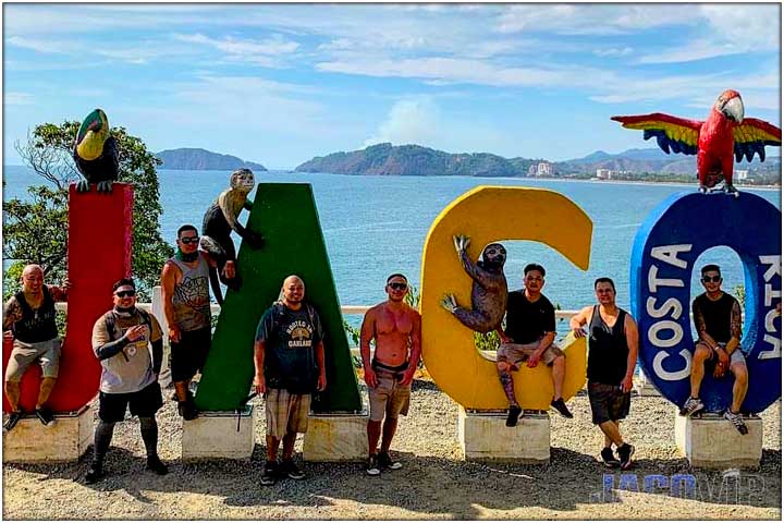 group of guys at Jaco sign