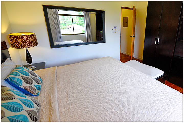 large mirron by the side of bed