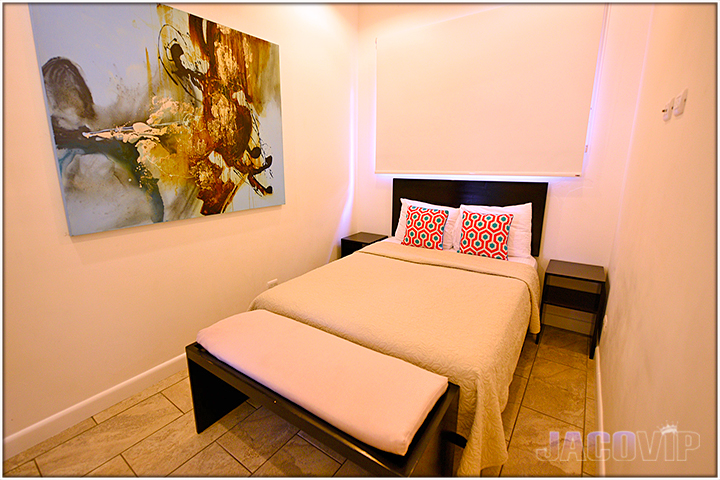 Smaller room with Queen size bed and modern art