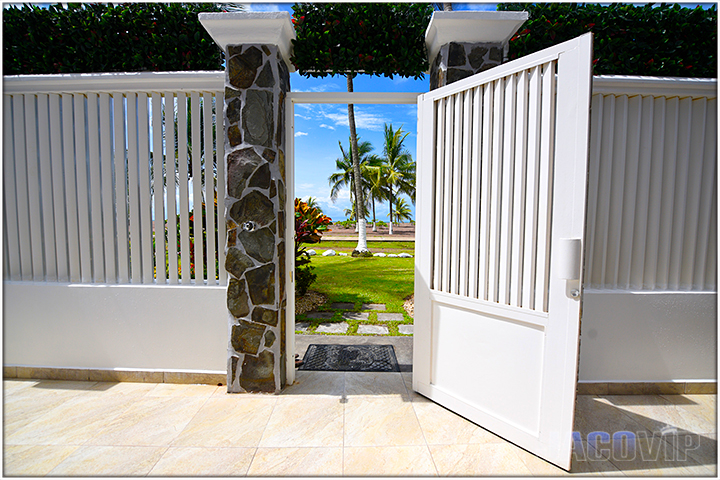 open gate looking out at Jaco Beach in Costa Rica