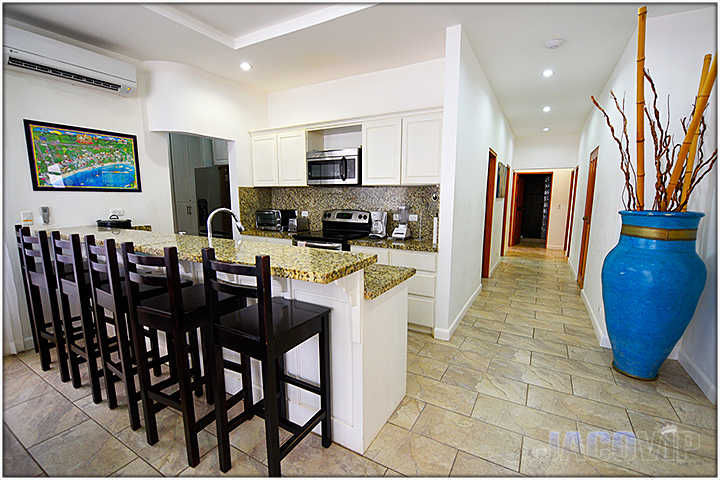 Kitchen area with bar and stoold