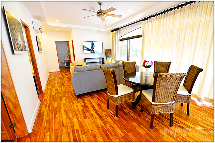Table and chairs, sofas and large TV