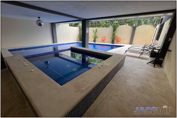 half covered pool area next to building