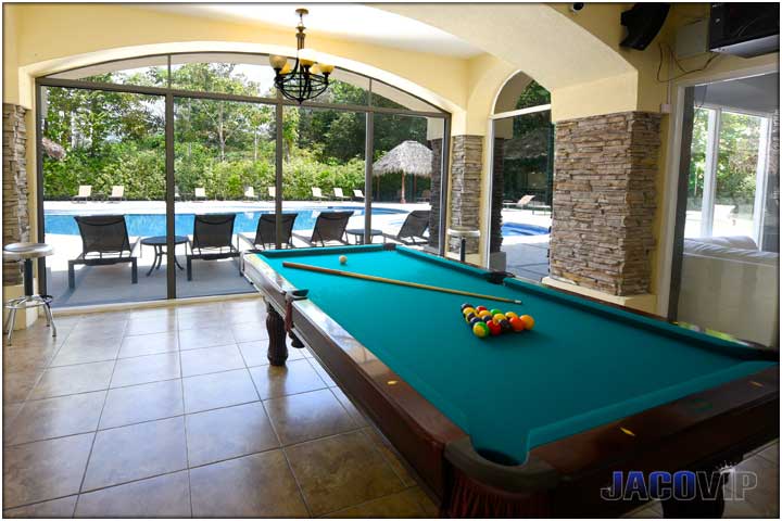Looking at swimming pool and outdoor area from the pool table