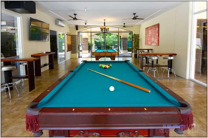 Two full size pool tables in living room