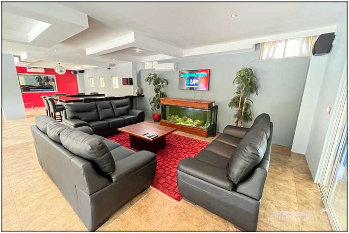 2 red chairs and large white sofa
