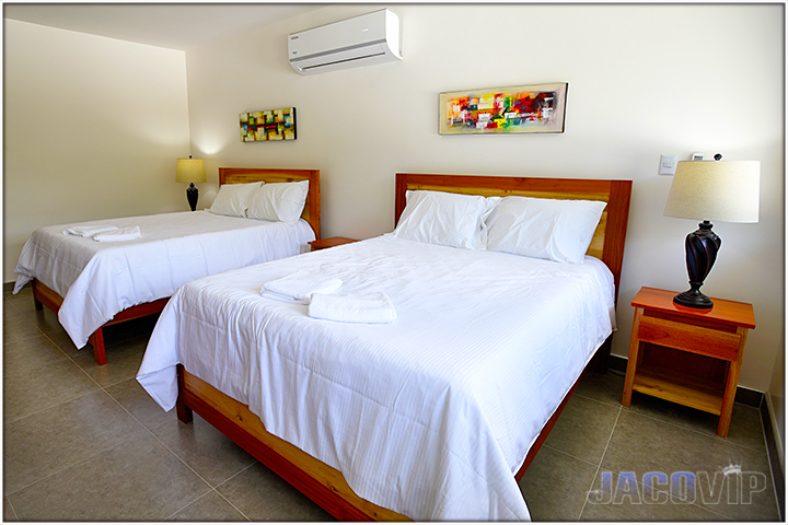 bedroom with abstract art above the beds