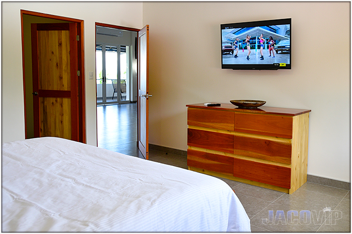 bedroom numer 2 with flat screen tv mounted on wall