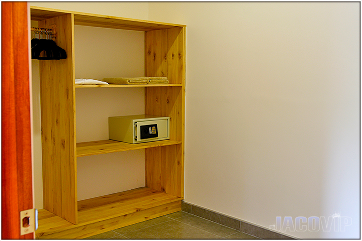large closet with mounted programmable safe