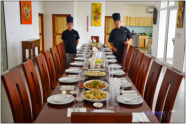 Large dining table with plate settings and 2 Jaco VIP chefs