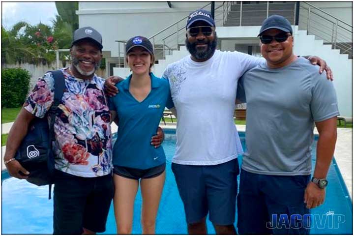 Guests with concierge in front of pool
