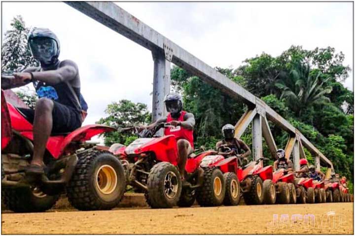 Long line of ATVs parked on Tulin bridge in costa rica