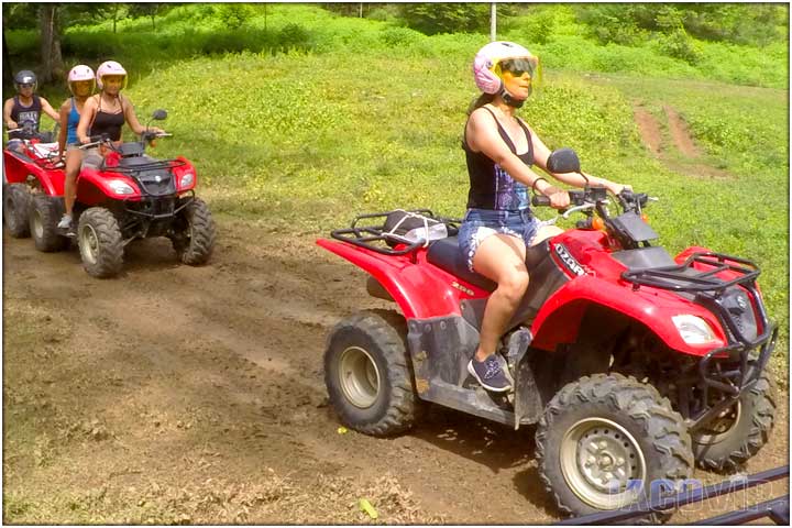 Girl driving ATV on path