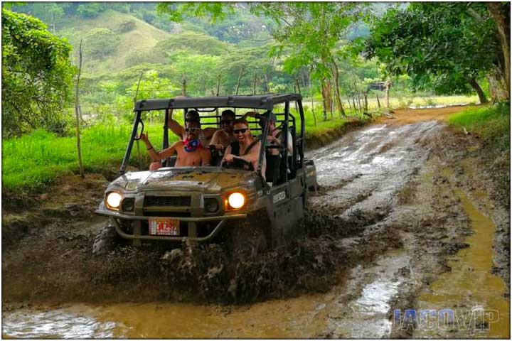 Quad side by side driving through mud