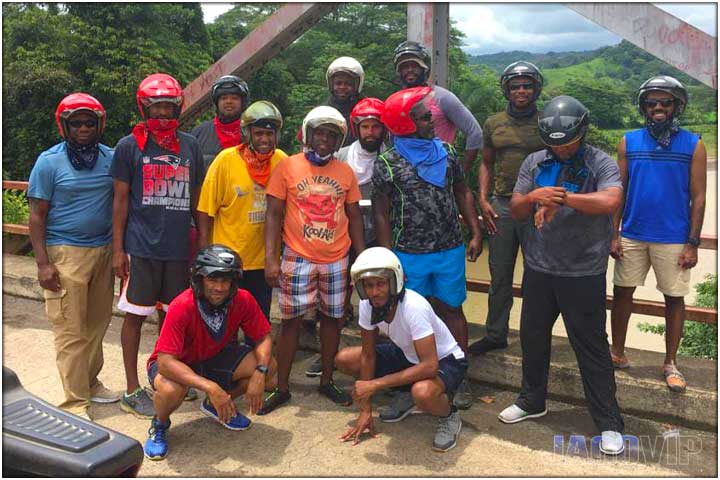 Group of guys posing on bridge during atv tour