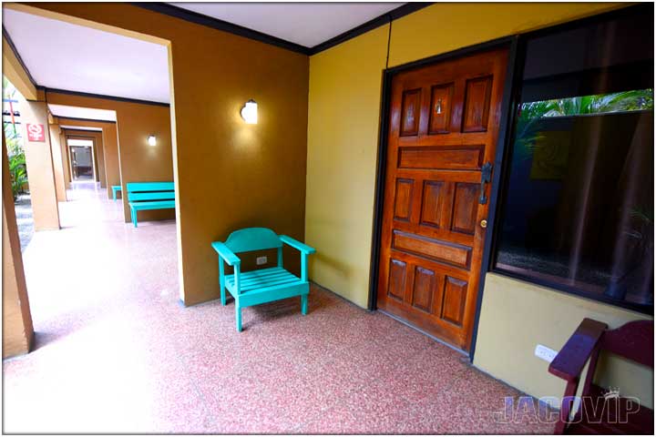 Exterior hallway with green wooden chair