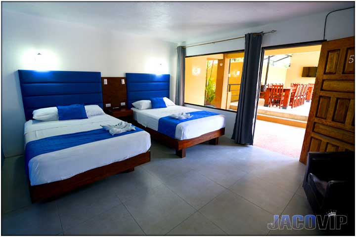 2 double beds with blue bed runners and blue accent pillows