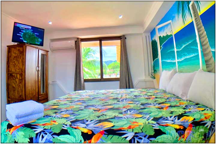Colorful bed spread on queen size bed