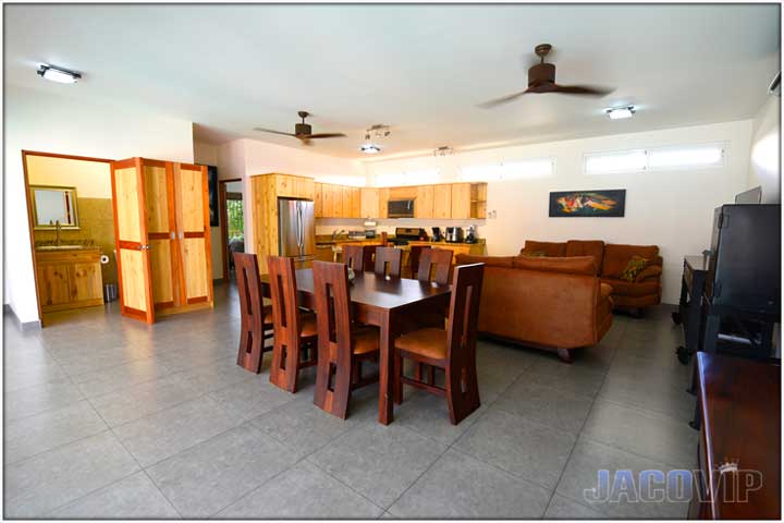 View of living room dining table and open door to bathroom