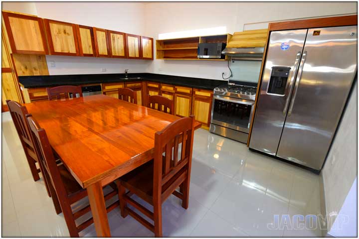 Close up of dining table and equipped kitchen