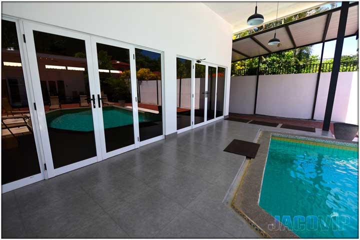 Close up of floor to ceiling windows and doors to first house