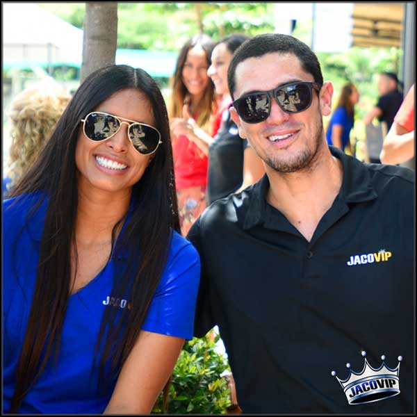 Two concierges smiling and wearing sun glasses