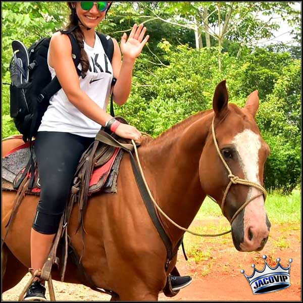 Woman riding horse on a horseback riding tour in Jaco
