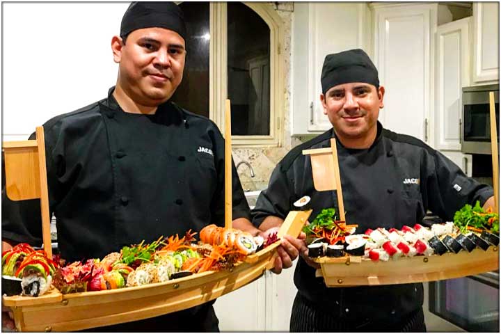 2 Jaco VIP Sushi Chefs with loads of sushi on 2 wooden serving boats