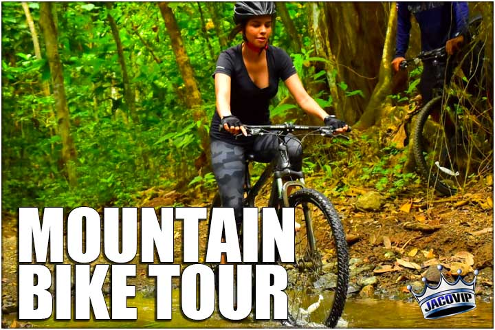 GIrl on mountain bike near waterfall in Jaco Costa Rica