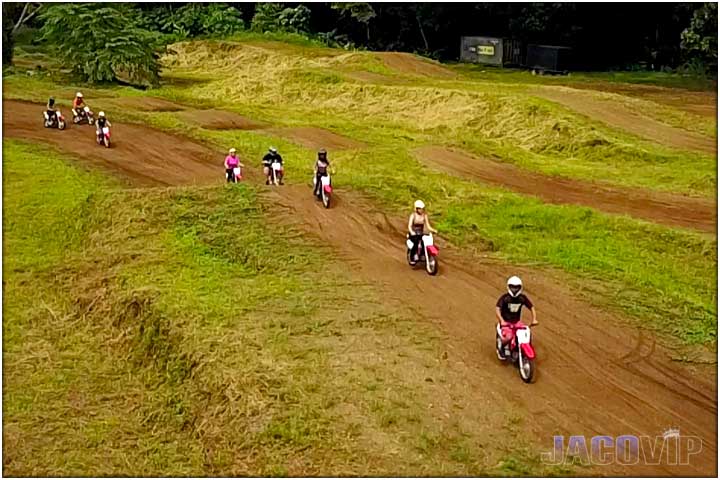 People driving mini dirt bikes in Costa Rica