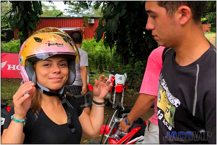 Guide placing helmet on girl in Costa Rica