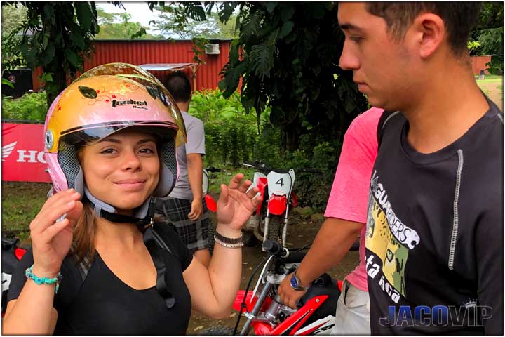 Guide placing helmet on girl in Costa Rica