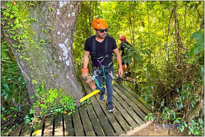 Guy on first platform of zipline tour