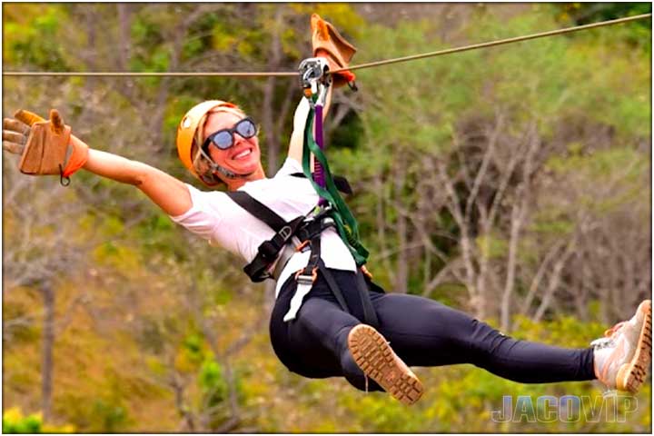 Girl with arms and legs open on zipline in costa rica